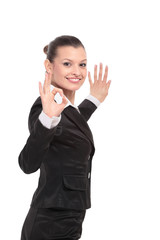 Attractive business woman is showing okay sign with happiness.