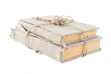 Two vintage books in an old cloth cover, rewound with a thread with a knot, on a white isolated background. Horizontal frame
