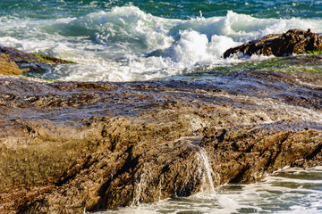 Seawater running through the rocks on Arpoador beach at Ipanema, Rio de Janeiro