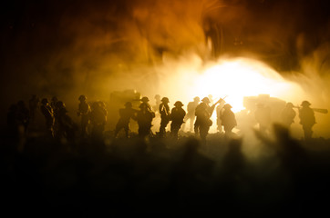 War Concept. Military silhouettes fighting scene on war fog sky background, World War Soldiers Silhouettes Below Cloudy Skyline At night. Attack scene. Armored vehicles