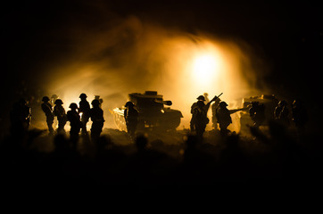Fototapeta na wymiar War Concept. Military silhouettes fighting scene on war fog sky background, World War Soldiers Silhouettes Below Cloudy Skyline At night. Attack scene. Armored vehicles