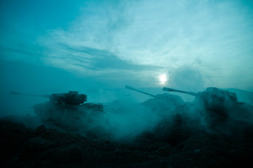 War Concept. Military silhouettes fighting scene on war fog sky background, World War Soldiers Silhouettes Below Cloudy Skyline At night. Attack scene. Armored vehicles. Tanks battle