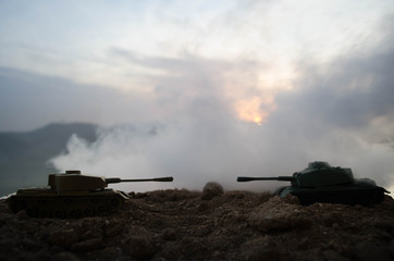 Fototapeta premium War Concept. Military silhouettes fighting scene on war fog sky background, World War Soldiers Silhouettes Below Cloudy Skyline At night. Attack scene. Armored vehicles. Tanks battle