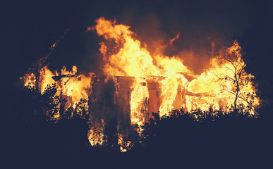 Big House fire in the night ligjt toned photo