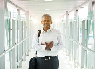 indian businessman outdoor with a computer tablet