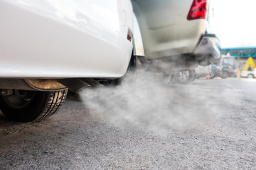 Car exhaust pipe comes out strongly of smoke, air pollution concept.