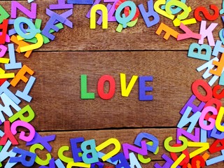 colorful wooden alphabet love spelling on wooden background