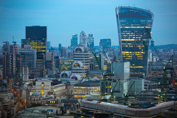 City of London business aria view at night. Walkie-Talkie building and Canary Wharf at the...