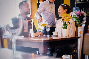 Black couple drinking wine.