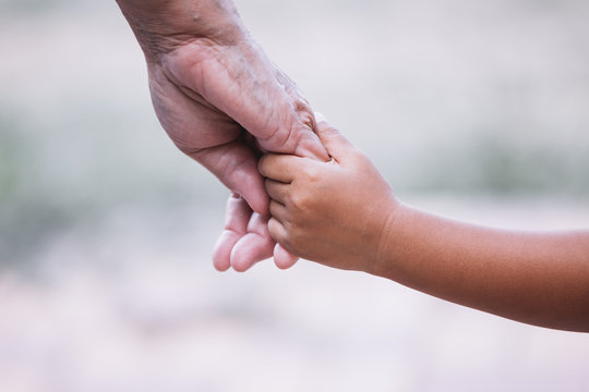 Grandmother And Child Little Girl Holding Hand Together With Love In Vintage Color Tone