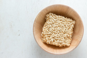 noodle in bowl on wood background top view