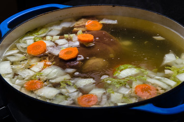 Vegetable ham soup cooking on the stove