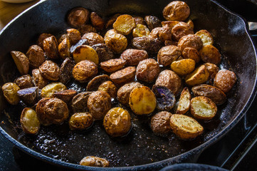 Cut potatoes frying in cast iron skillet