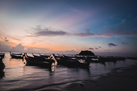 Ships on the beach in morning day.  Saturated colors and vibrant detail make this an almost surreal image.
