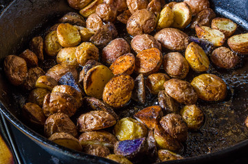 Cut potatoes frying in cast iron skillet