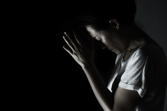 depress woman praying in the dark ( praying in secret room concept )