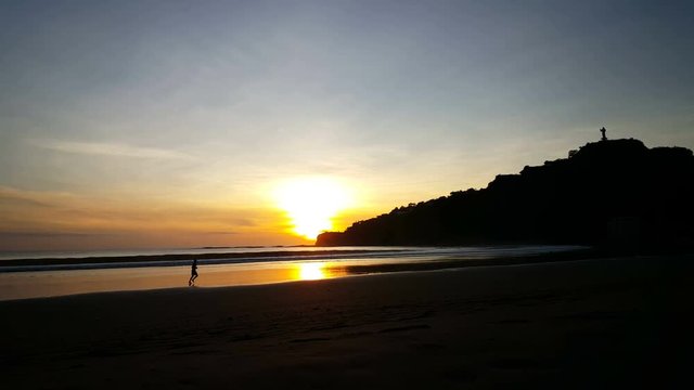 Man running at sunset on the beach of San Juan del Sur