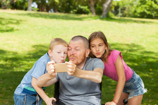 Disabled father playing with children.