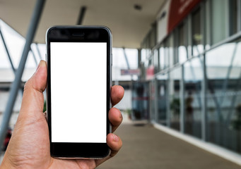 Close up of a man using smart phone with blank and laptop.Smart phone with blank screen and can be add your texts or others on smart phone.