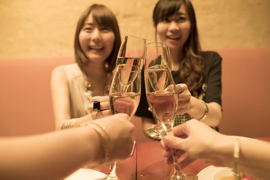 Four people are drinking with champagne