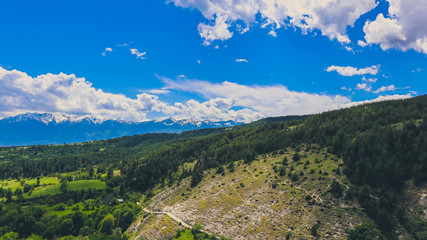 Fototapeta na wymiar Photo depicting a beautiful colorful amazing mountain meadow paradise landscape, summertime. European alpine mountains bathed in sunshine on a blue sky background.