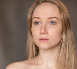 Portrait of a beautiful young woman with blue eyes.