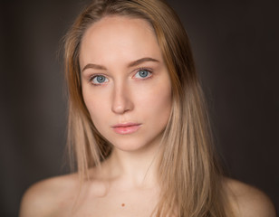 Portrait of a beautiful young woman with blue eyes.