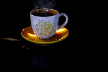 Hot coffee on a black background..