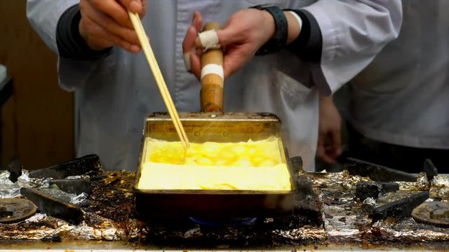 Japanese Chef Frying omelette on rectangular pan