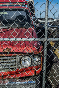 Red Diesel Truck At Used Auto Recycling And Dismantling Facility.