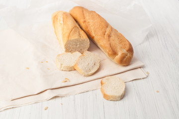 two French baguette on a white table
