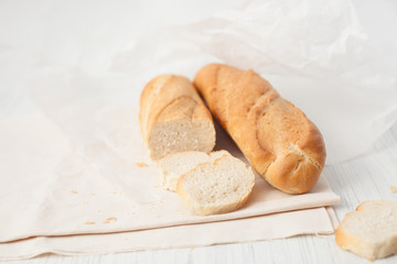 two French baguette on a white table