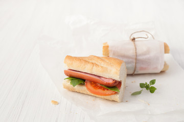 Sandwich with sausage on a white background.