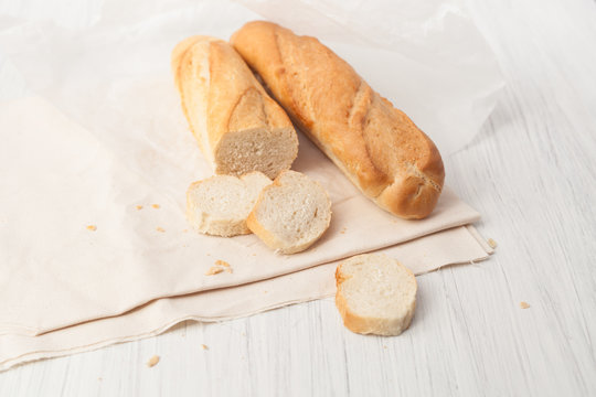 two French baguette on a white table