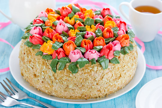 Delicious cake decorated with colorful cream flowers
