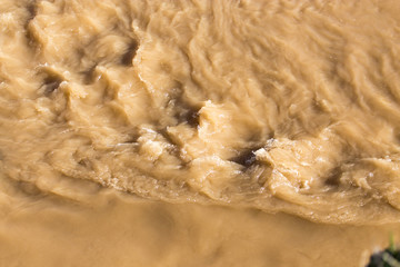 Dirty water in a stormy river as a background
