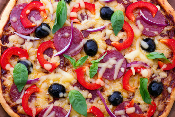 Delicious pizza served on wooden table. Italian pizza close up, top view, horizontal