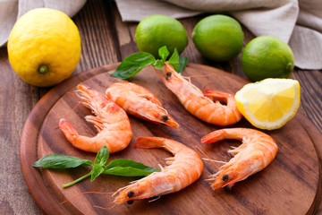 Delicious fresh seafood shrimp with lime on wooden table