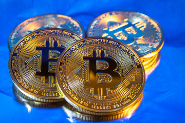 Cryptocurrency physical golden bitcoin coin on colorful background