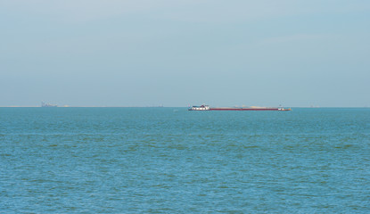 Barge sailing in a lake in spring
