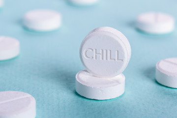 A pill with the word chill. Green background