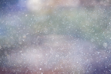 Obraz na płótnie Canvas Snowfall texture of snowflakes on blurred background
