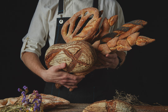 Variety of bread hold men's hands