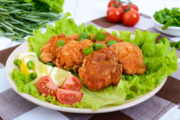Fried caviar of river fish with lettuce leaves, cherry tomatoes on a light background. A dietary dish. Healthy eating.