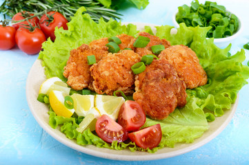 Fried caviar of river fish with lettuce leaves, cherry tomatoes on a light background. A dietary dish. Healthy eating.