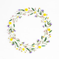 Fototapeta na wymiar Flowers composition. Wreath made of yellow flowers and eucalyptus leaves on white background. Flat lay, top view