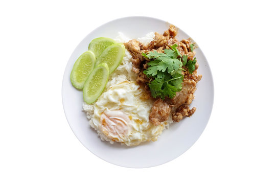 Rice with pork fried with garlic and black pepper and fried egg isolated on white