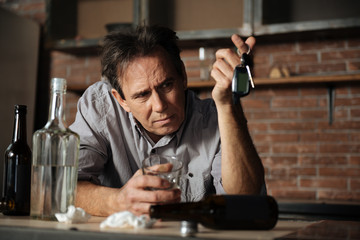 Pessimistic brunette looking at his keys