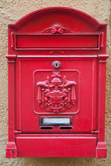 The old classic mailbox is red..