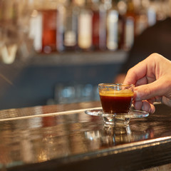 Hand holds cup of coffee